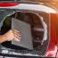 thief-stealing-a-laptop-from-a-car-through-a-broken-window